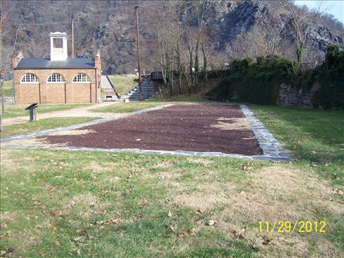Photo views dated November 29, 2012, showing the site of the Large Arsenal foundation wall footprint, established as an interpretive exhibit, Arsenal Square, Lower town, Harpers Ferry NHP/NPS.