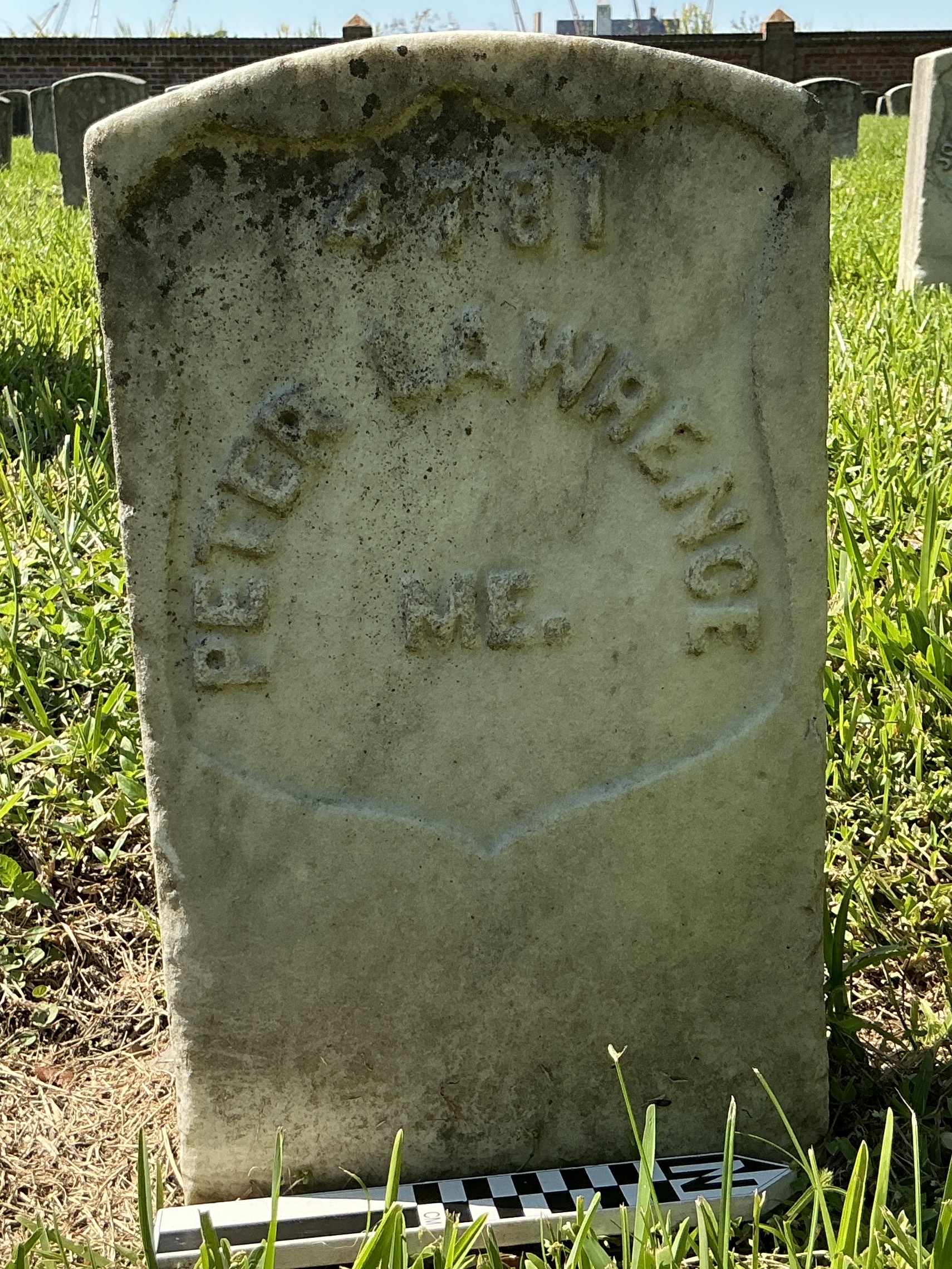Extra image of historic upright marble headstone with recessed shield face.