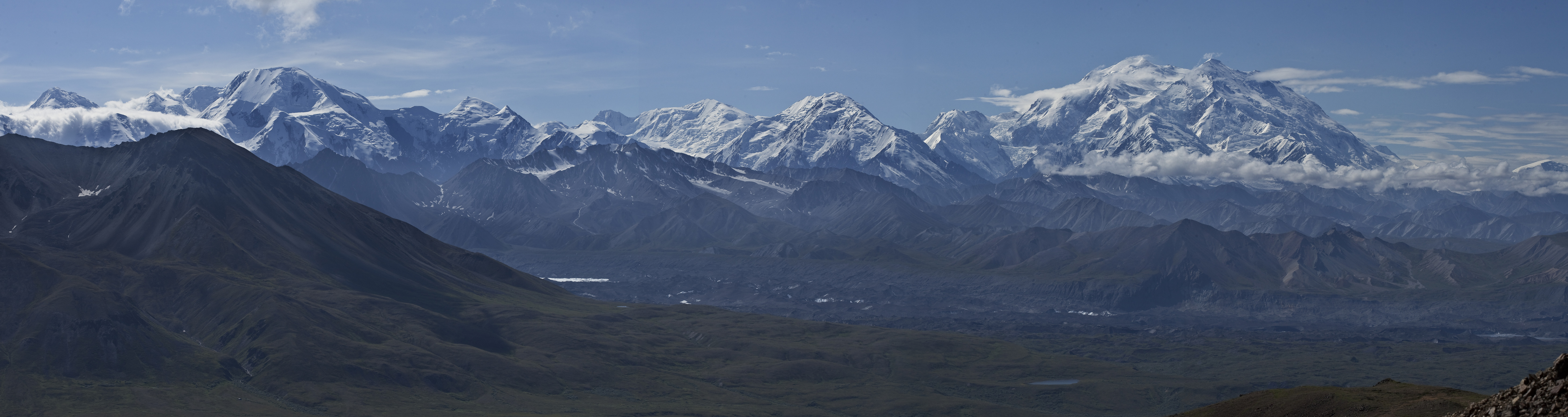 landscape of mountains growing higher and snowier til culminating in a huge mountain