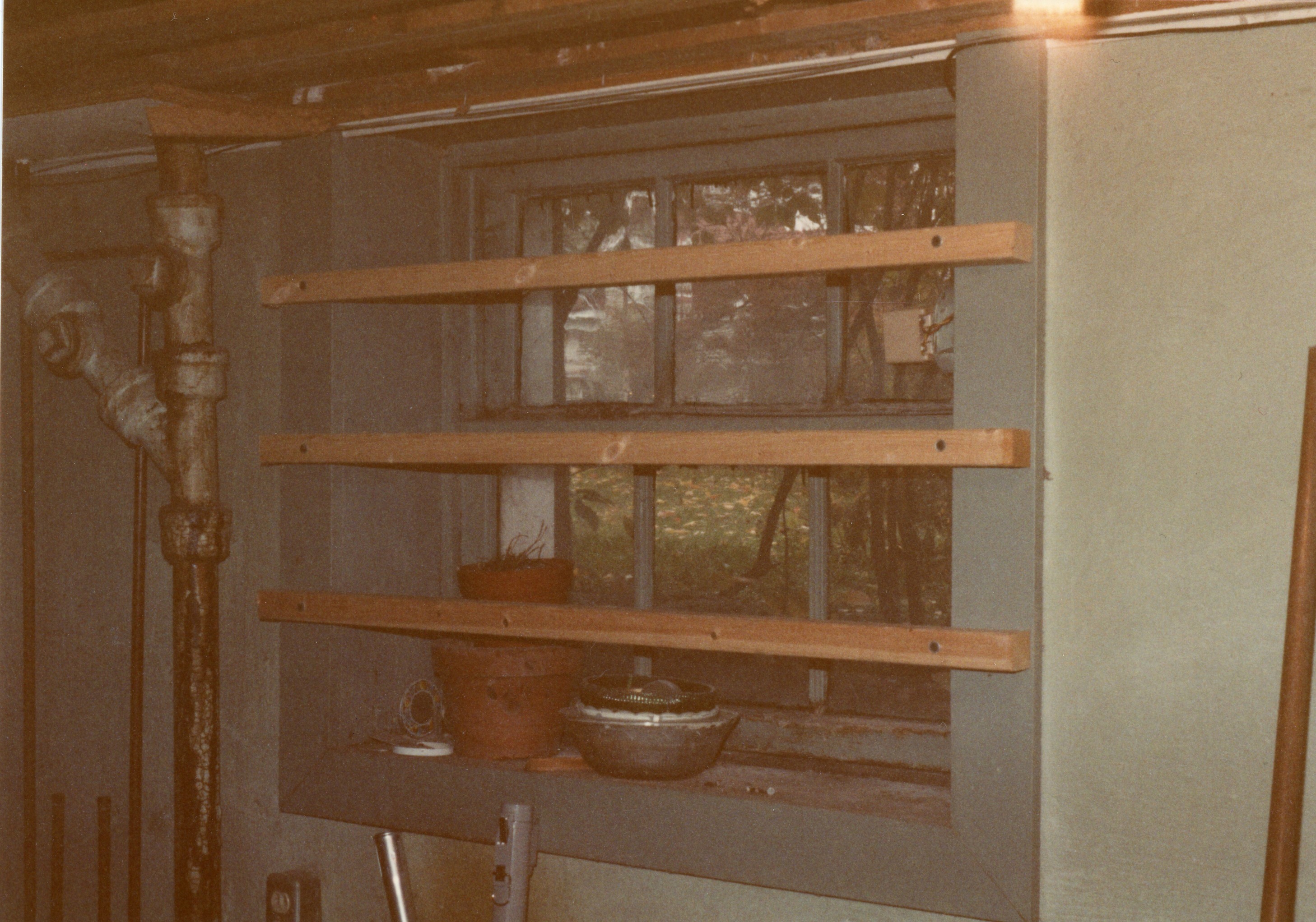 basement window with planks and items