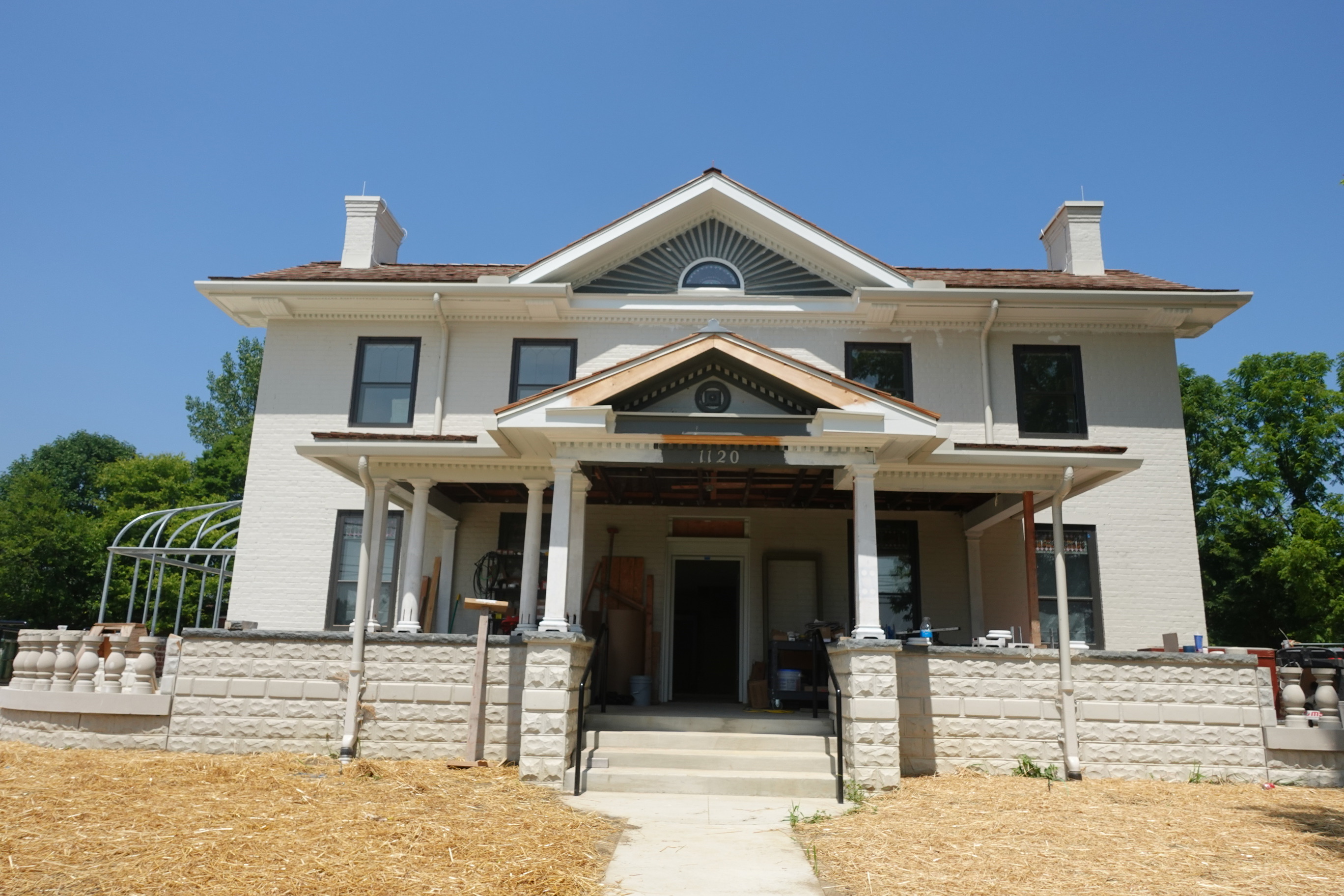 Front of a two-story grey brick home under construction