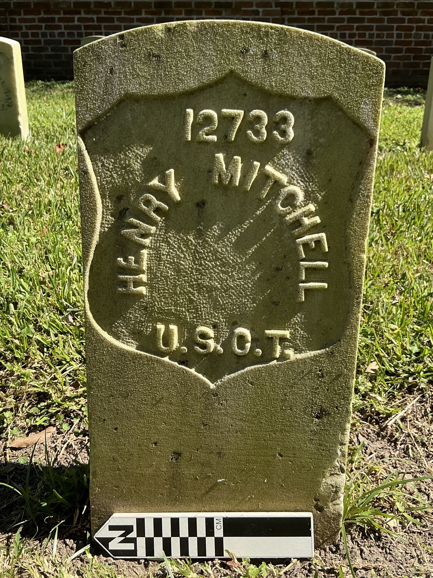Extra image of historic upright marble headstone with recessed shield face.