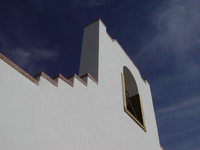 A white building with a clock on it.