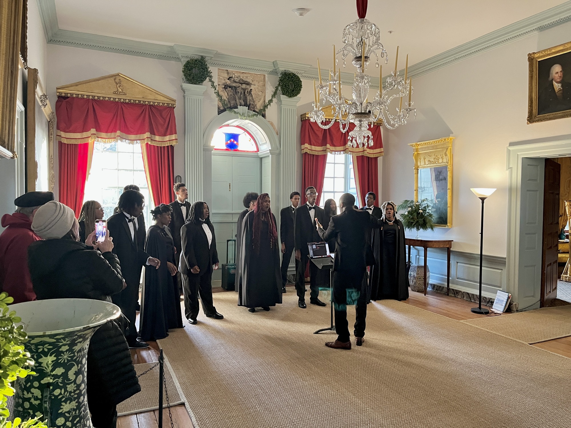 Visitors watching ConneXions Academy performing in the mansion