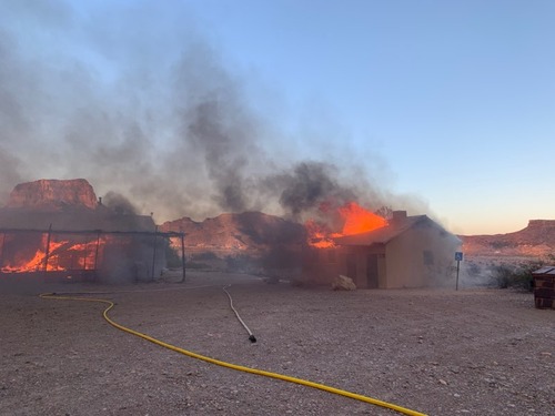 Fire burning the historic latrine and La Harmonia Store.