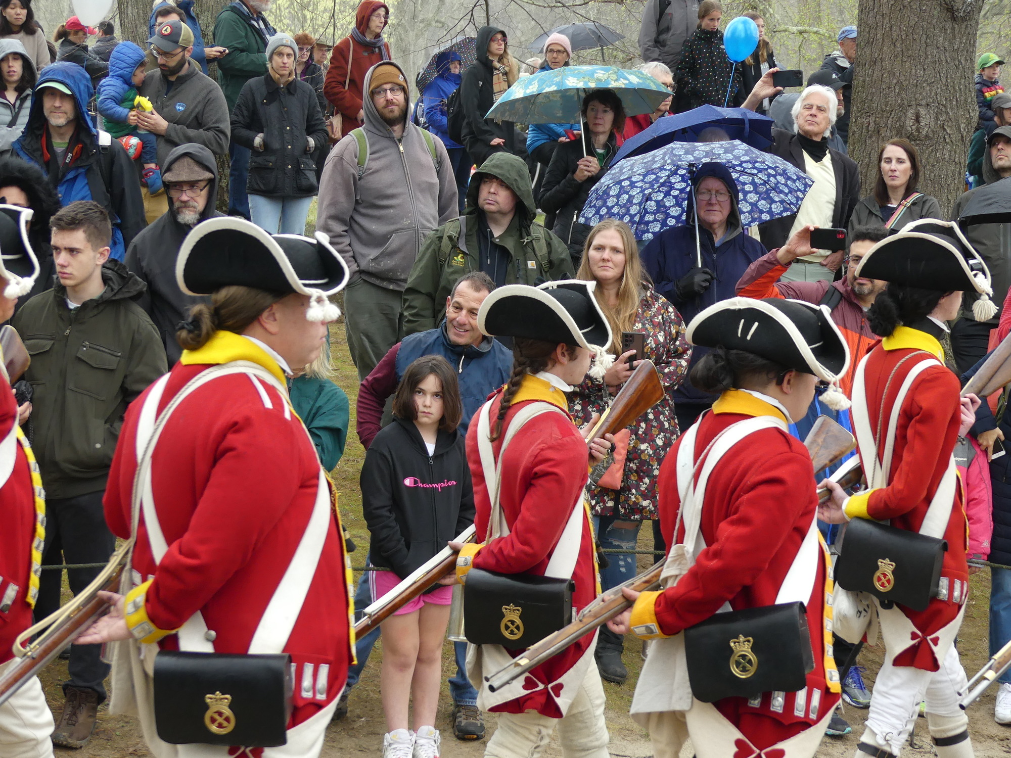 British troops giving honors to the fallen, with large crowd of visitors in the background 