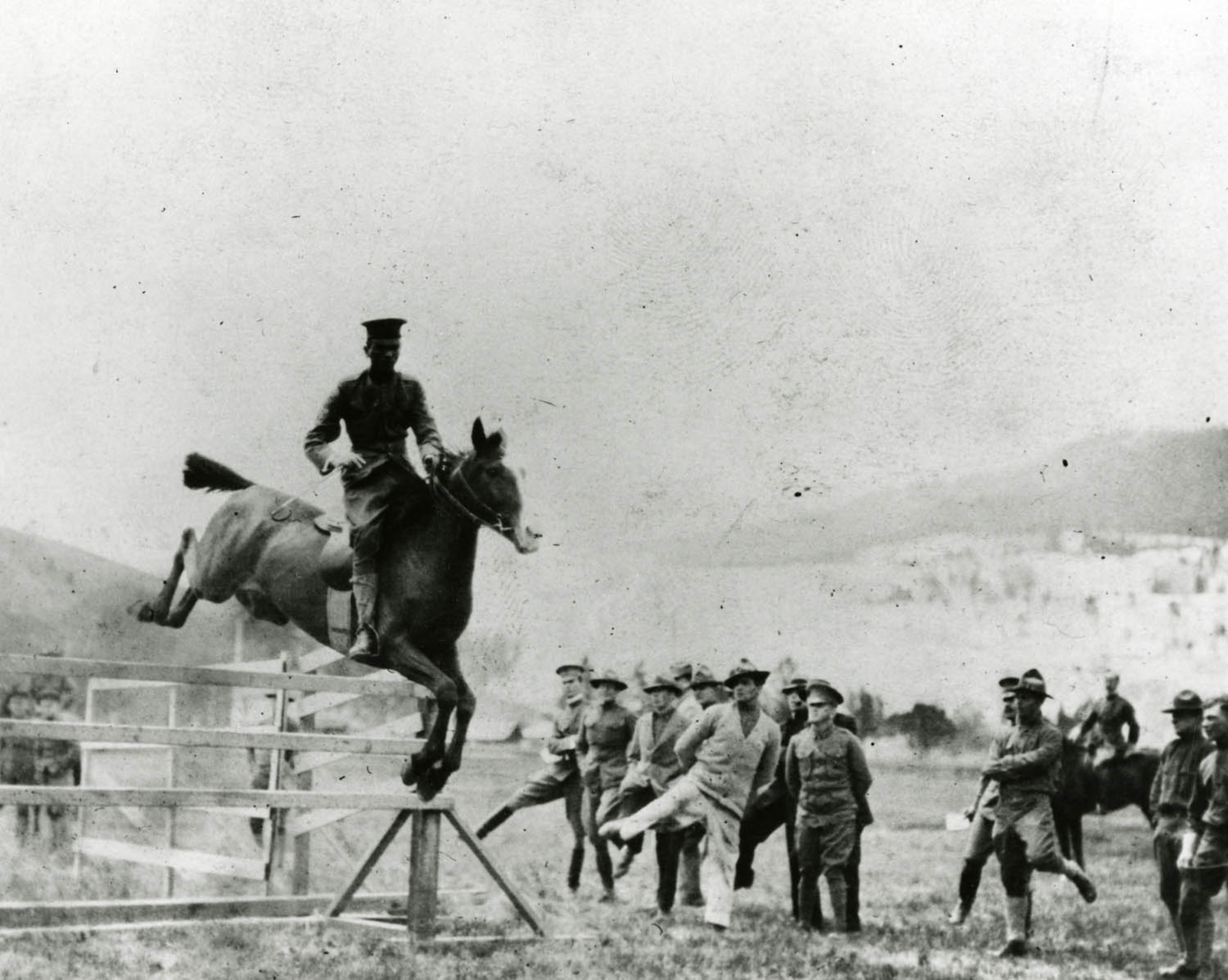 Sergeant McCartney jumping a fence on horseback