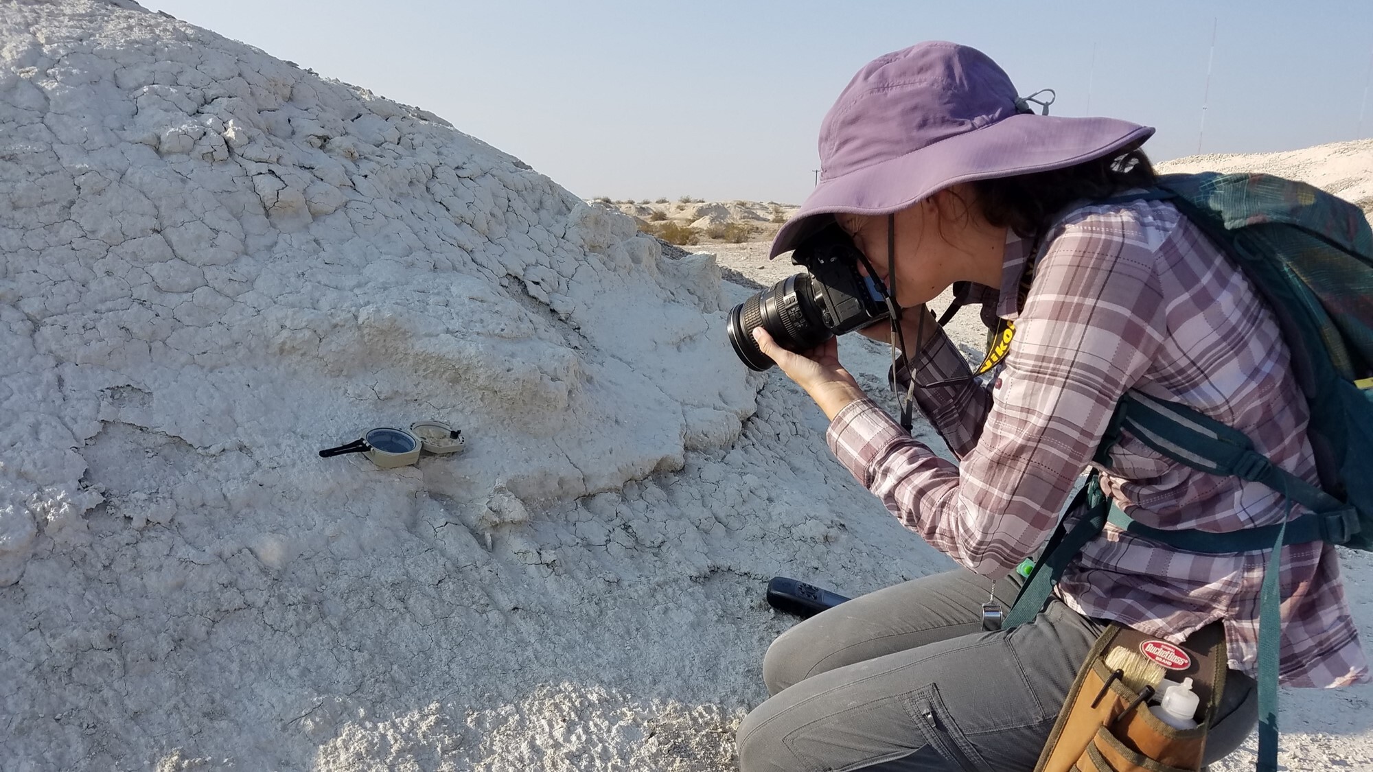 Person with a camera taking pictures of rocks