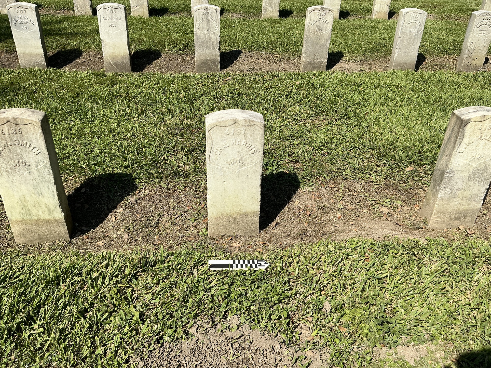 Extra image of historic upright marble headstone with recessed shield face.