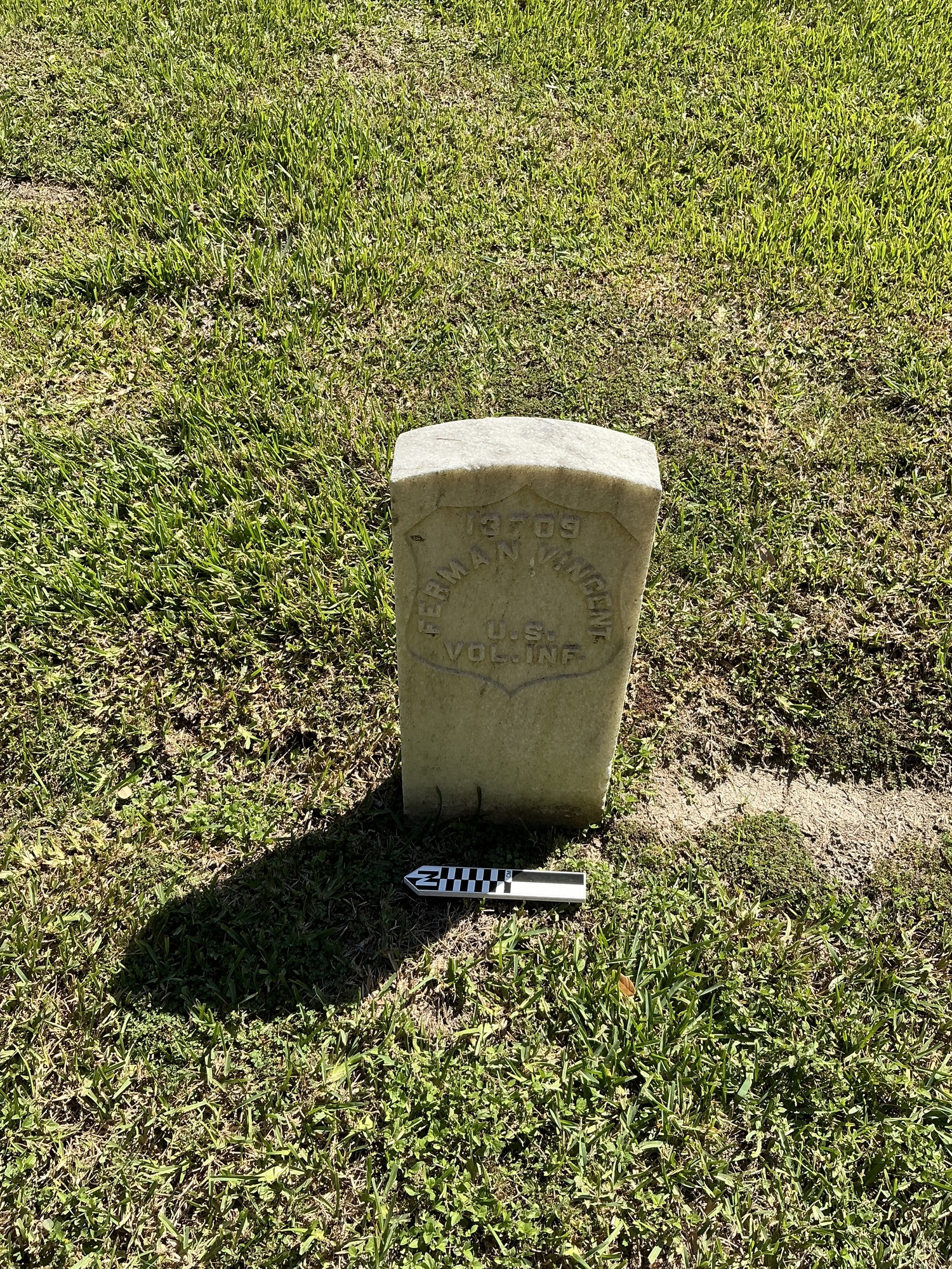 Extra image of historic upright marble headstone with recessed shield face.