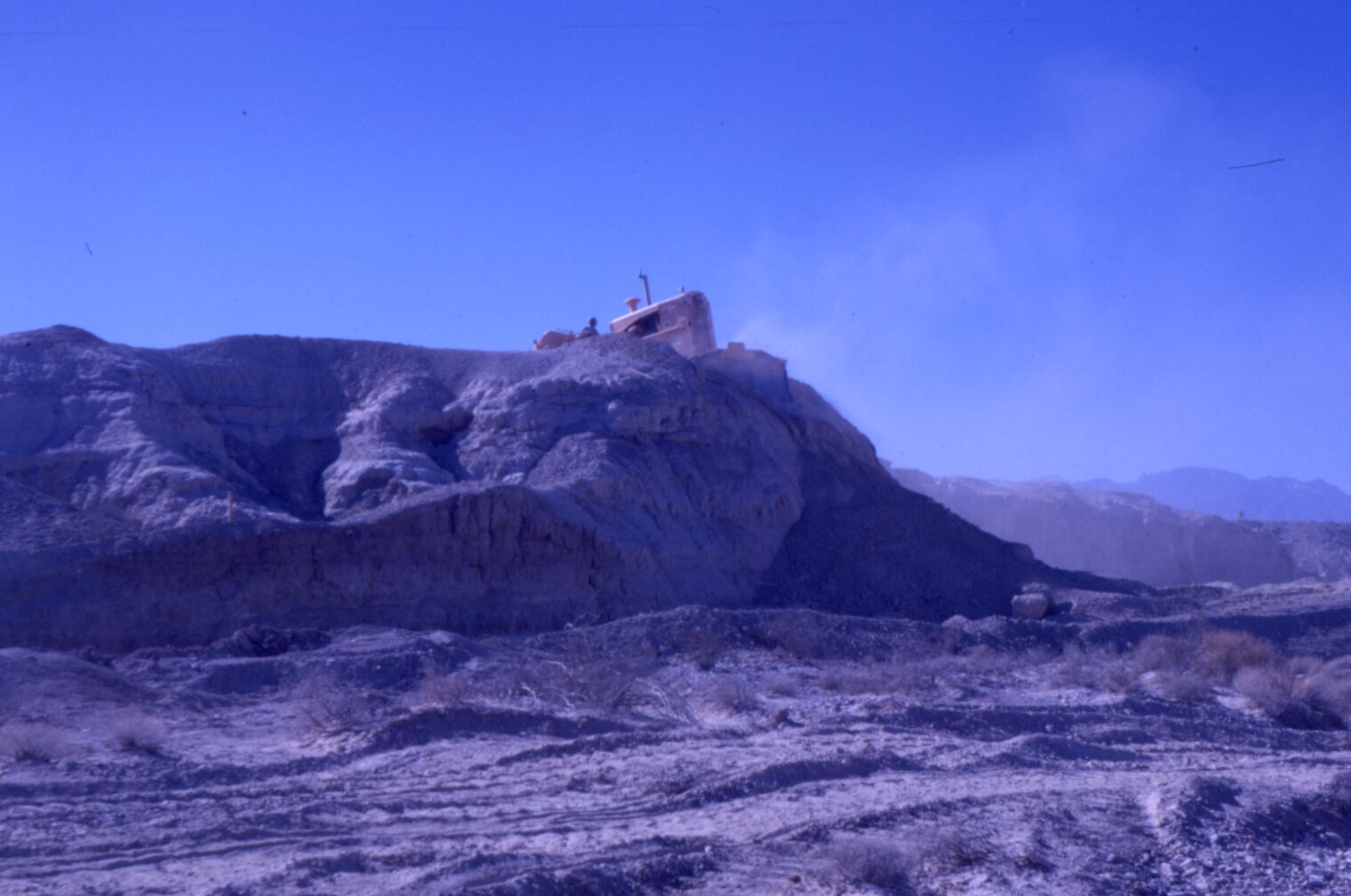Image of a trencher cutting on top of a slope