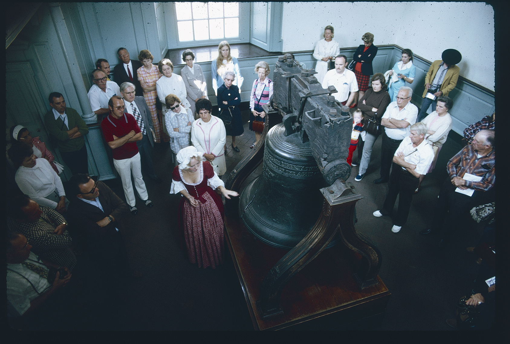 Independence Hall. Interior. Tower Stairhall. Looking down northwest at 1st floor. Tour guide in period costume showing visitors the Liberty Bell.