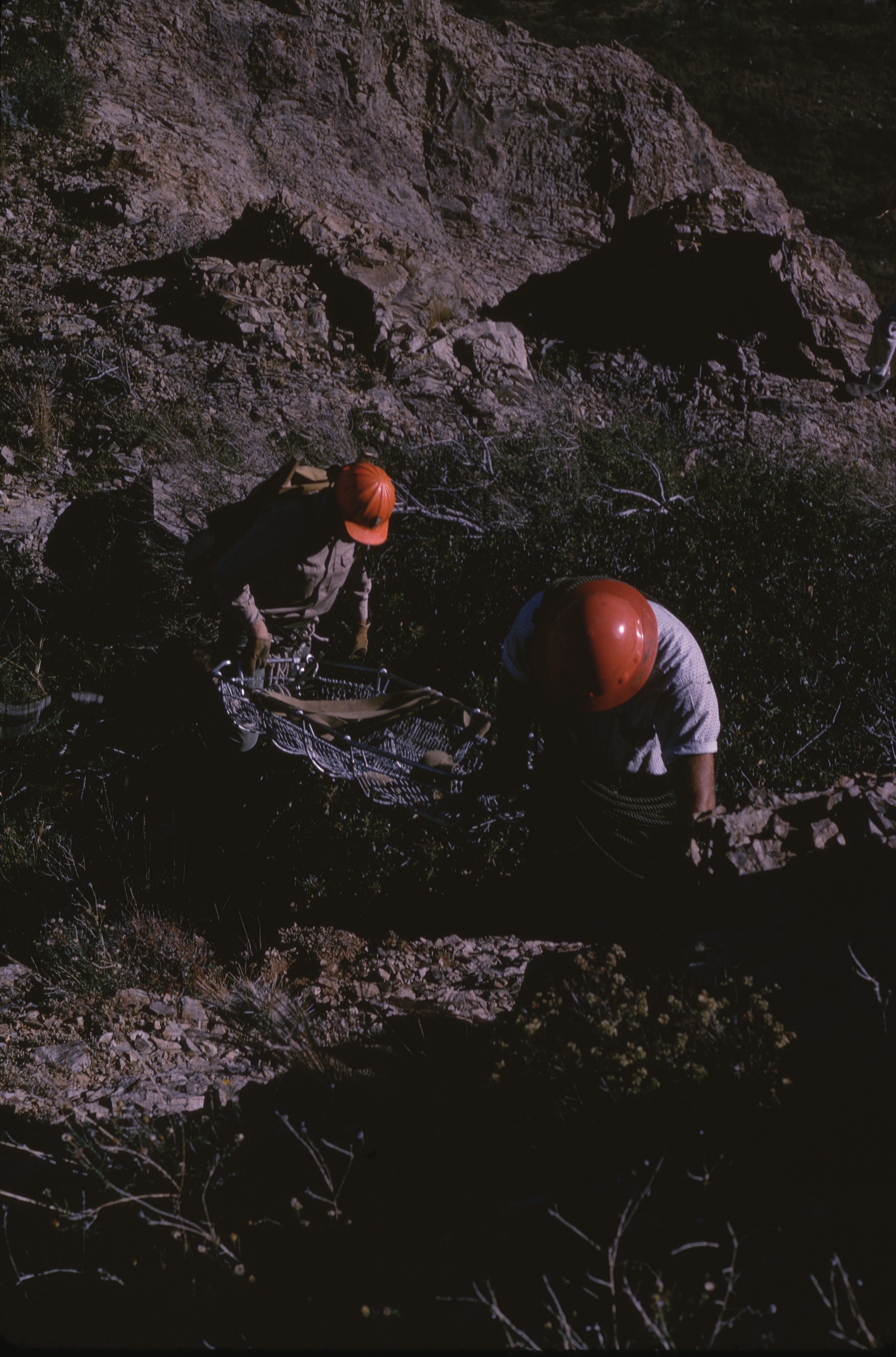 SAR personnel lowering rescue litter