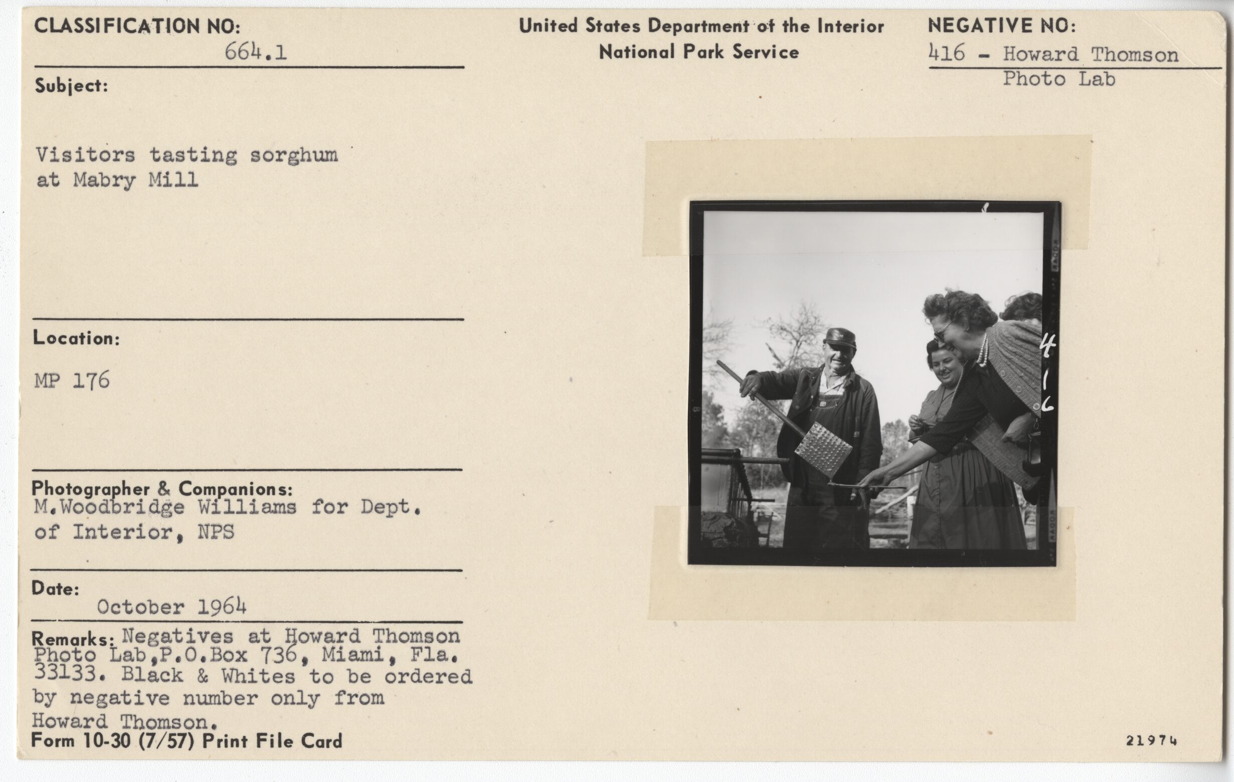 Visitors testing sorghum at Mabry Mill