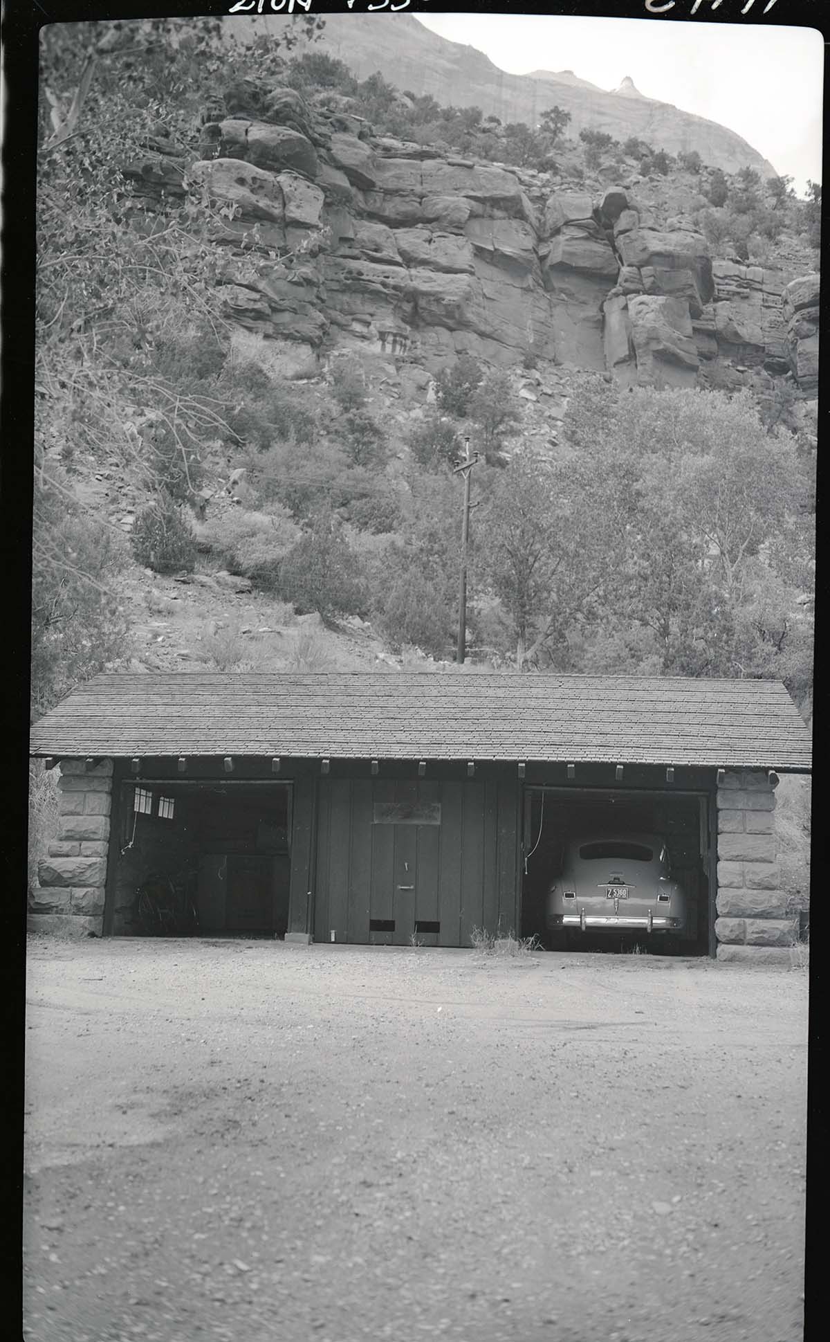 Three car garage, Building 102, headquarters area with car.