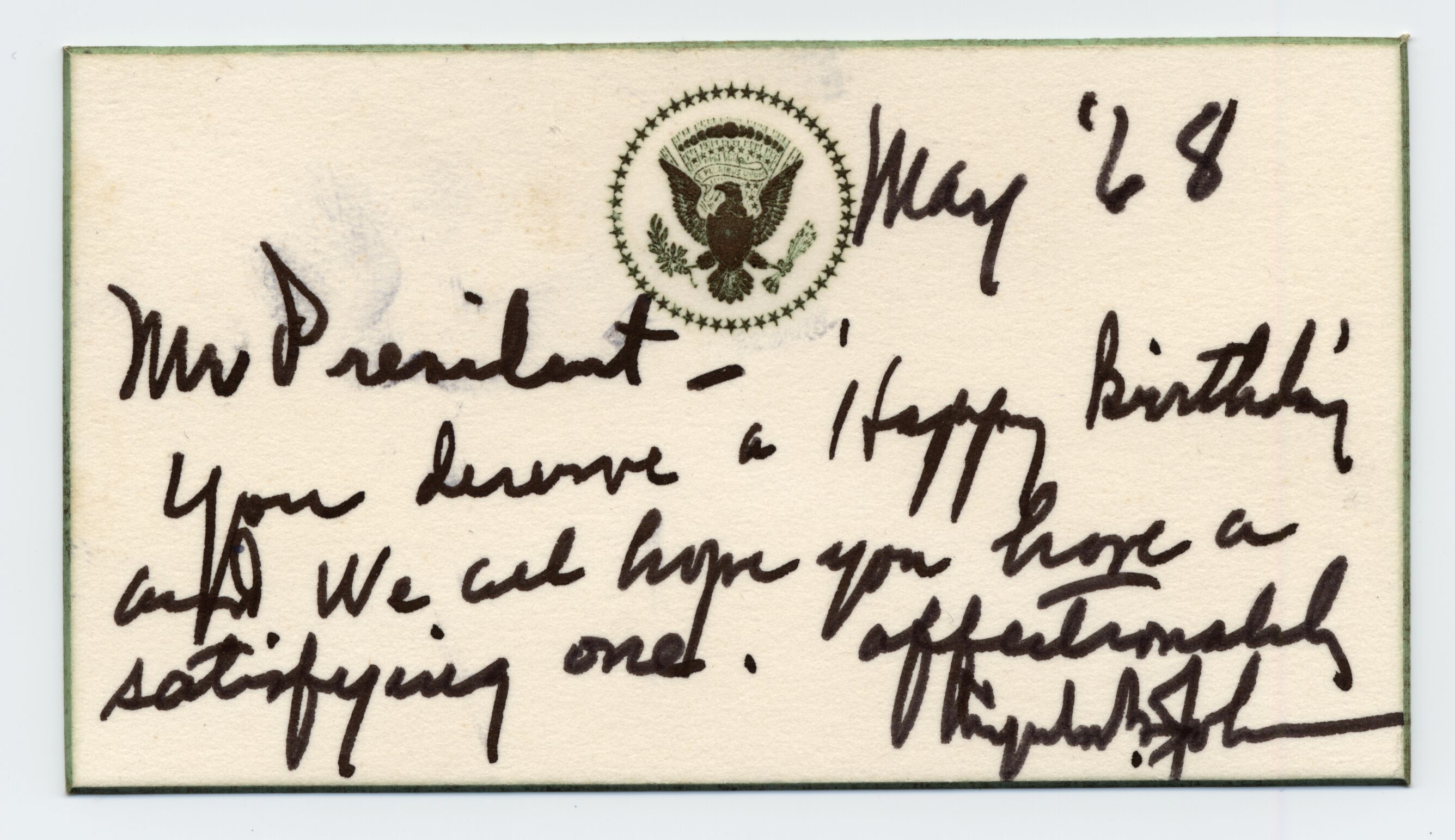 A small birthday card with an embossed seal, written in black marker.