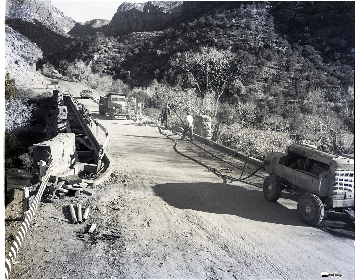 Smoothing bridge edges by chiseling and removal of blasted debris.