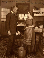 Man dressed in suit talking to women in dress