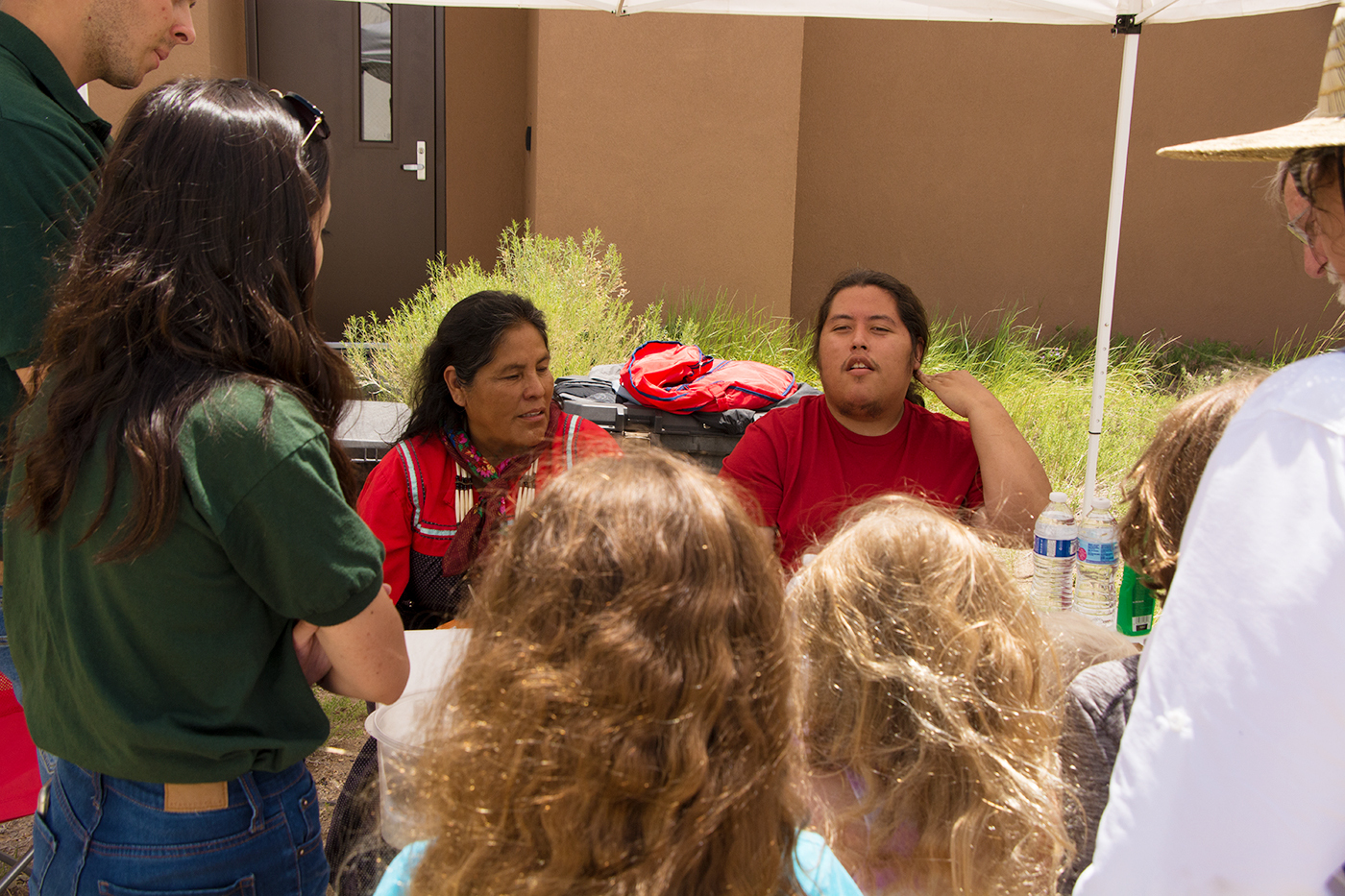 A Jicarilla Apache woman and her son tell traditional stories to an audience at the visitor center. 