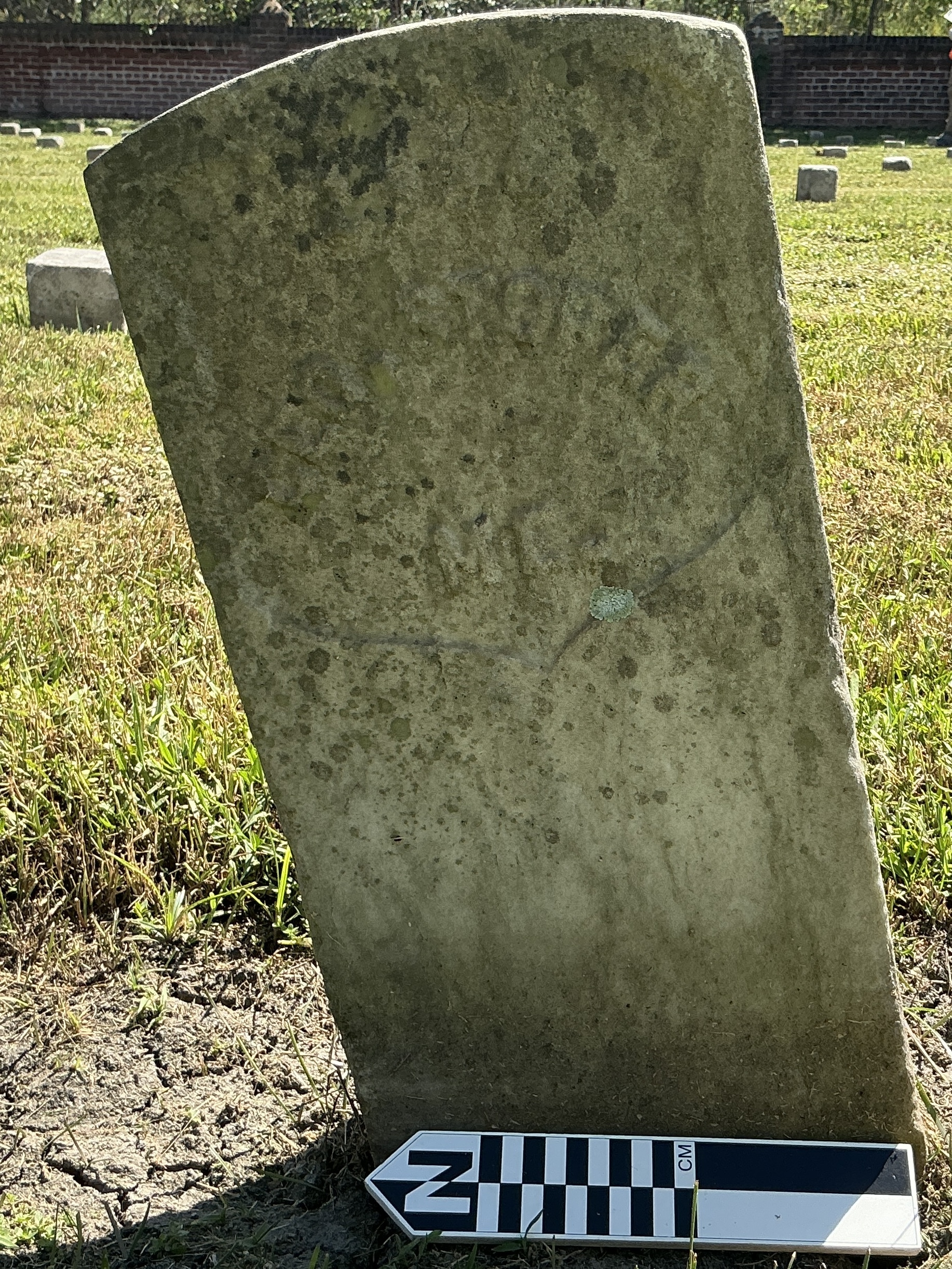 Extra image of historic upright marble headstone with recessed shield face.
