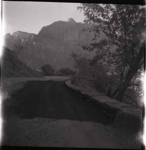 Road and completed rock retaining wall alongside road at the tunnel.