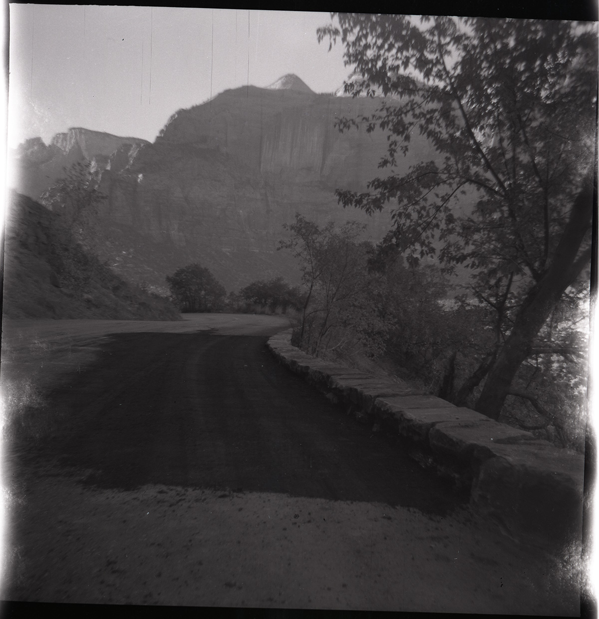 Road and completed rock retaining wall alongside road at the tunnel.