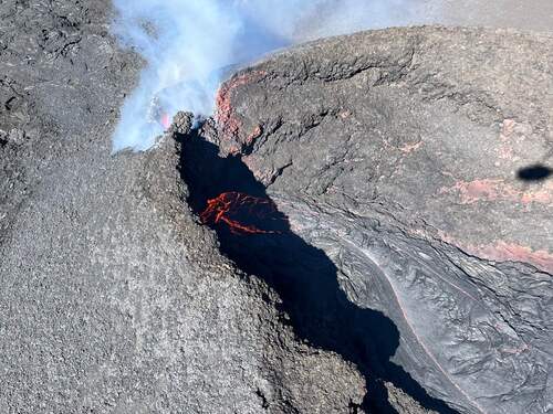 Cinder cone with a small pond of lava within it. The cone produces a small gas plume. 