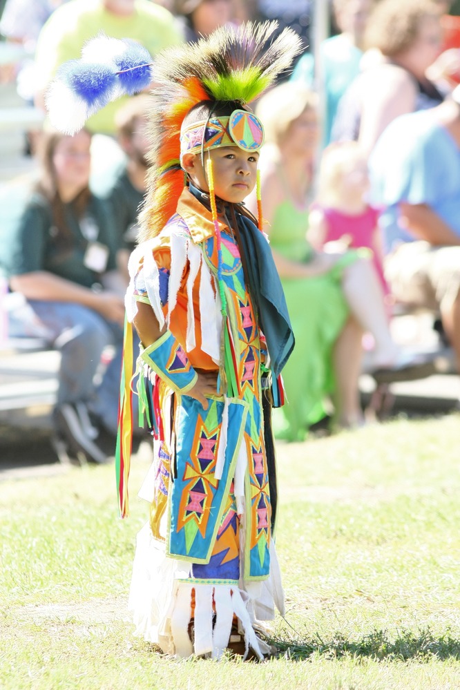 A young boy Muscogee (Creek) dancer in regalia.