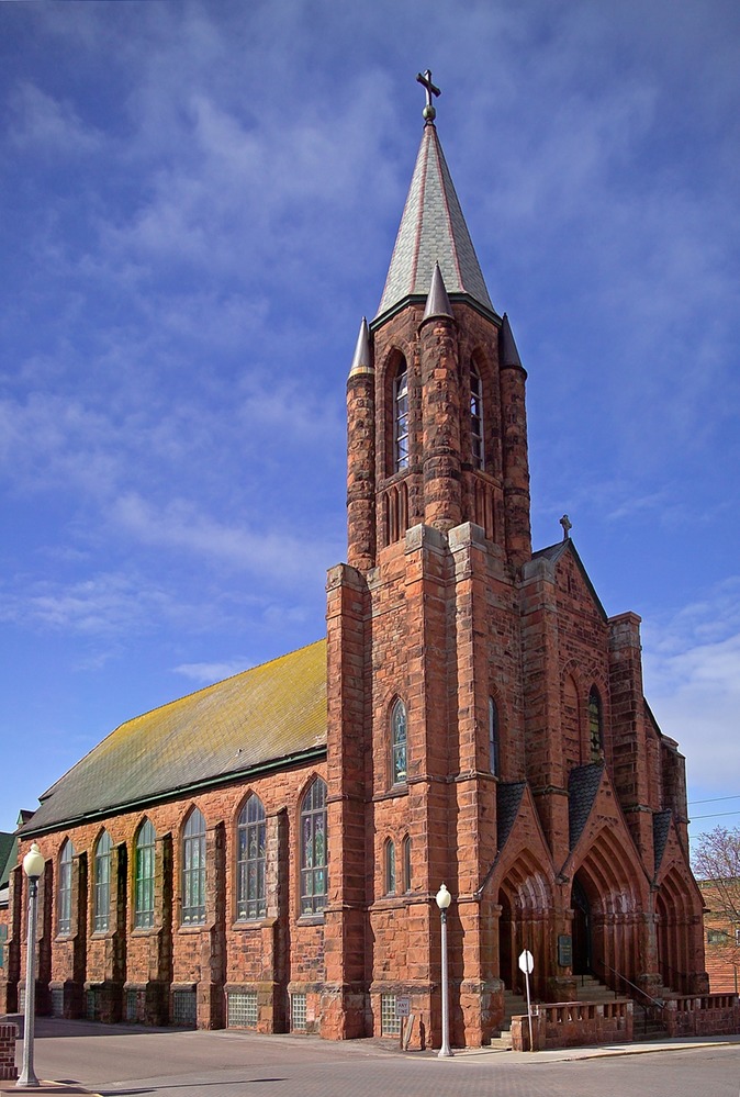 This imposing Gothic Revival church was built of locally quarried Jacobsville sandstone in 1900 for a growing French-Canadian Catholic population. It was deconsecrated in 1966 after the population of Calumet decline when the mines closed. The Keweenaw Heritage Center has conducted restoration efforts of the structure.