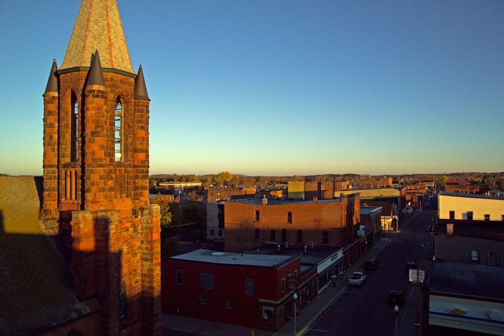 Morning light illuminates the steeple of St. Anne's and Calumet's commercial district.