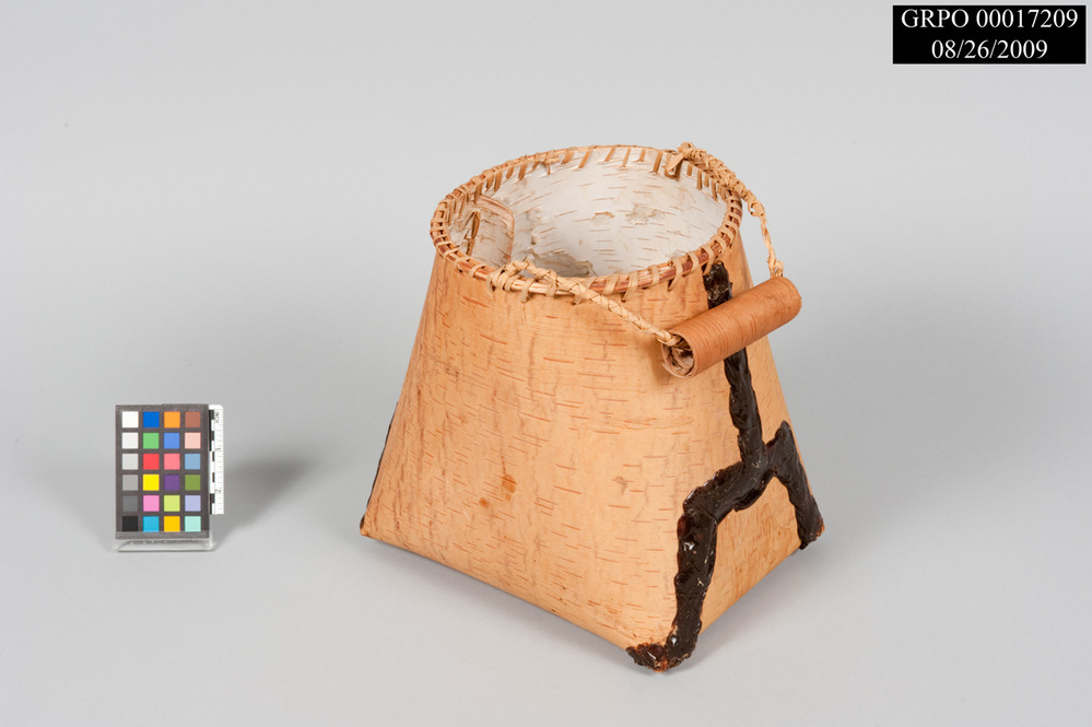 Conical birch bark basket sealed with black pitch.
