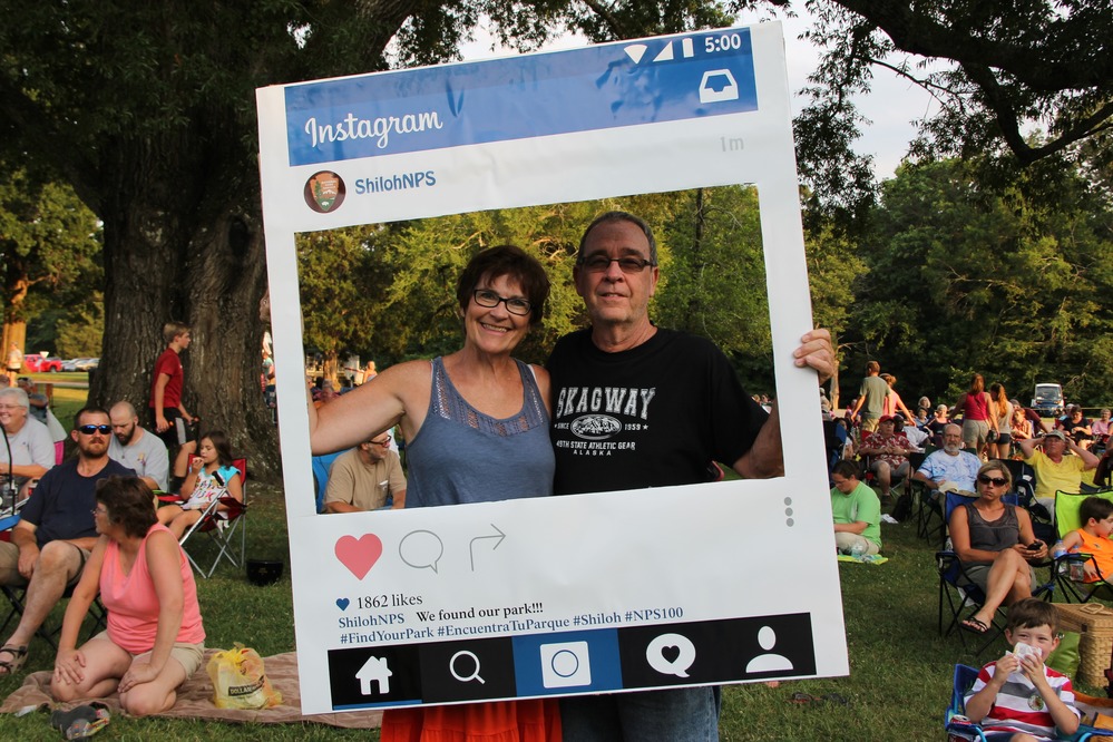 Couple poses with Instagram Sign