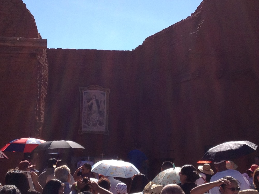 a copy of the painting "Our Lady of the Angels" hangs on the wall of its ancestral home at the Pecos Mission Church.