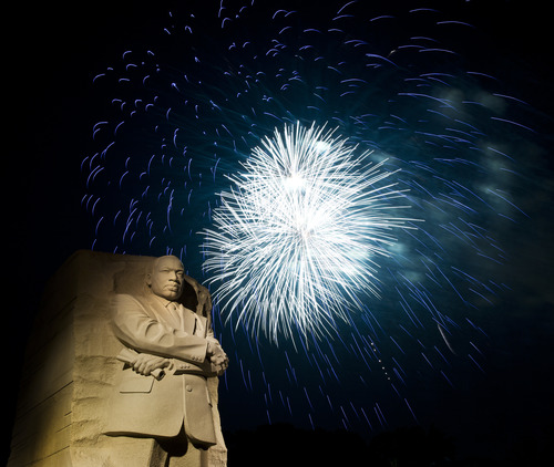 Fireworks go off in a display behind the Martin Luther King, Jr. Memorial at night