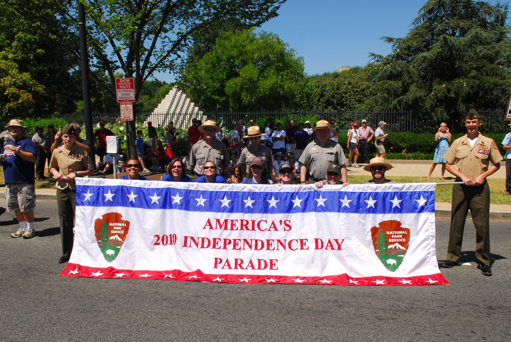 Park Rangers along with military, volunteers, and other groups present sign for 2010 Independence Day Parade