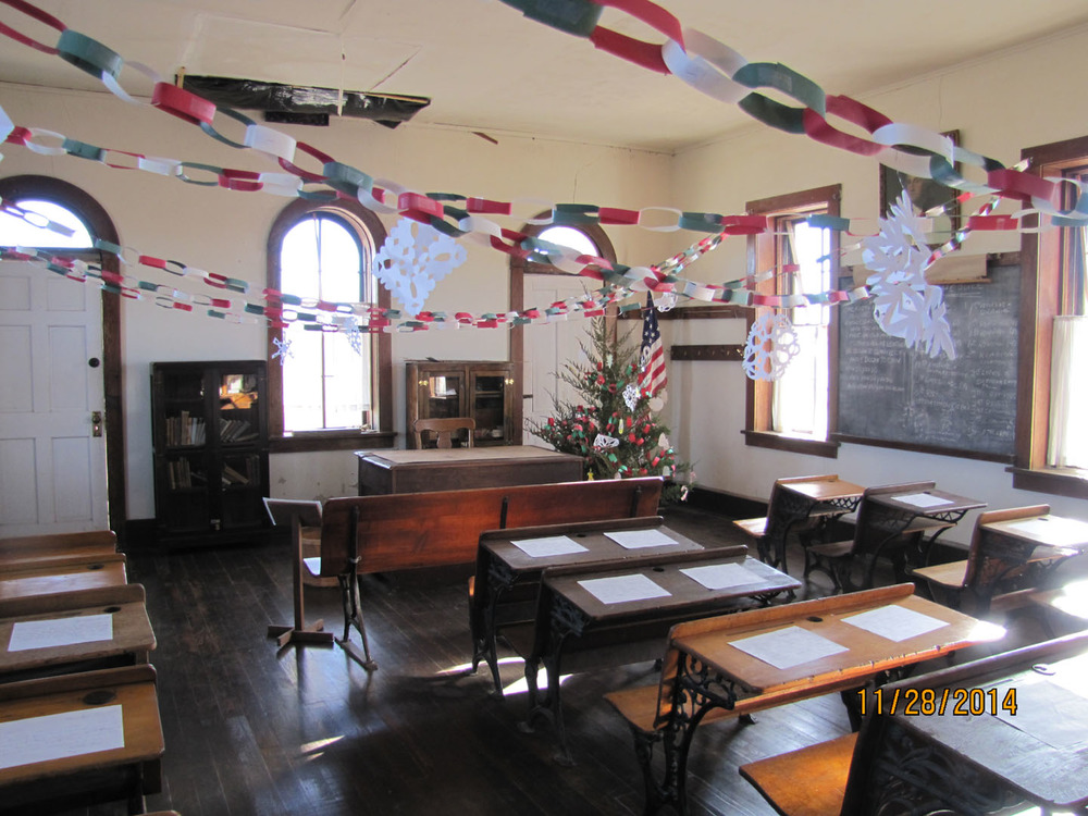 Interior photo of the one-room school decorated for Christmas