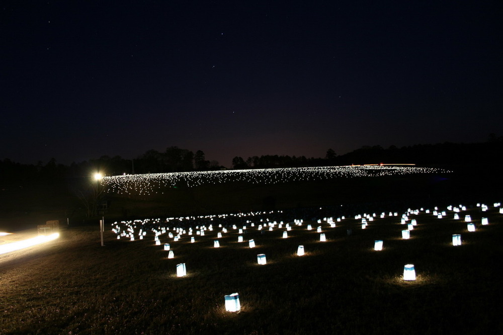 Candle luminaries light up the prison site