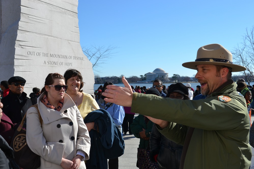 Ranger Townsend speaks about the Martin Luther King, Jr. Memorial to a group of visitors.