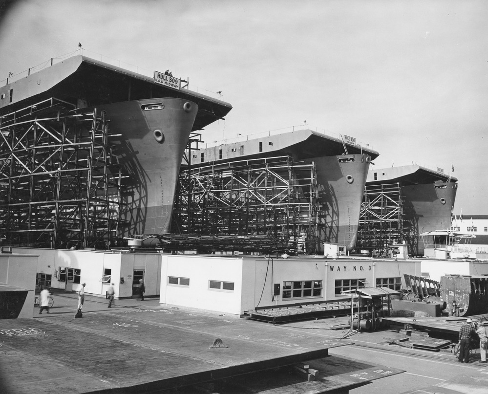 Three large aircraft carriers in dry dock under construction