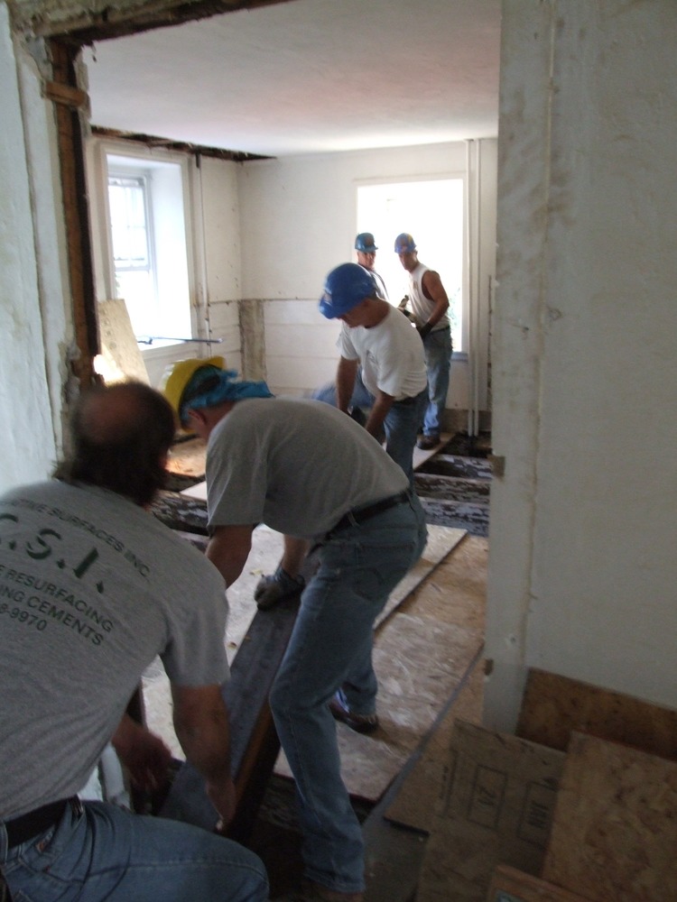 Placing structural steel beam into floor.