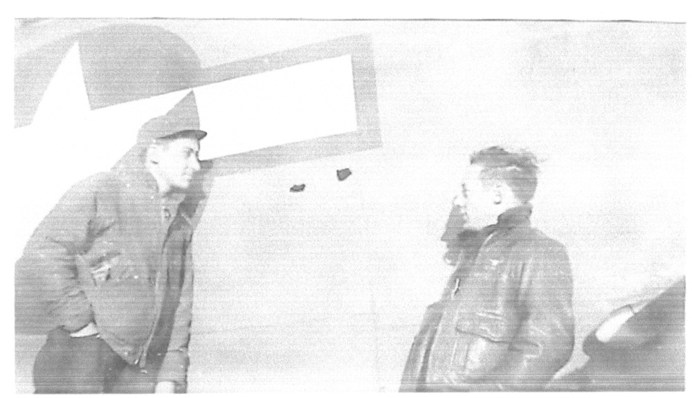 Aviators looking at fuselage holes