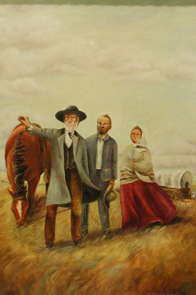 Three pioneers stand with a horse on the prairie