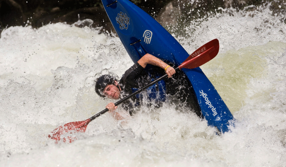 kayaker flips over in whitewater 