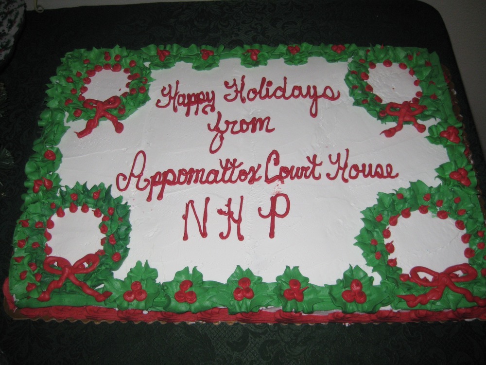 Green and red decorated cake wishing visitors Happy Holidays.