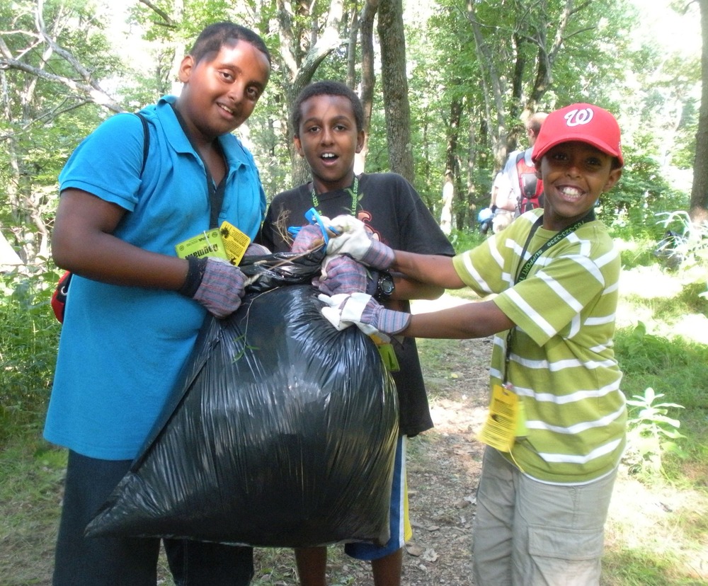 Proud of a job well done - one of many bags of invasive plants pulled by campers!