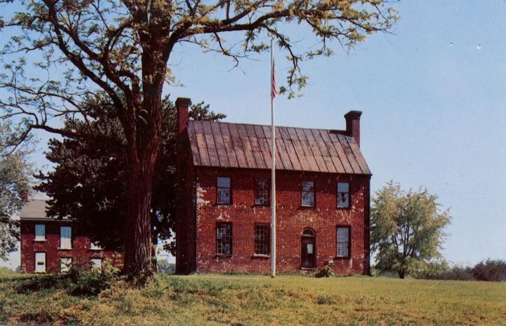 Postcard of Clover Hill Tavern & kitchen. Both buildings are brick two story buildings with the larger tavern in the foreground and the smaller kitchen to the left and behind.
