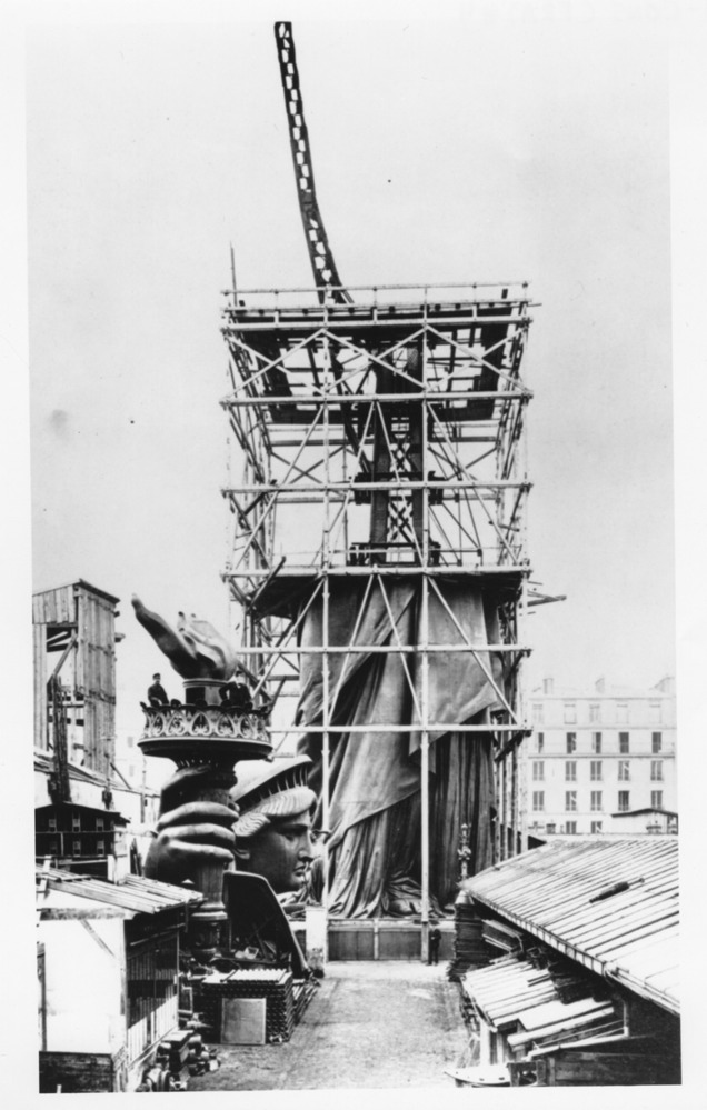 The statue is scaffolding in Paris, about halfway completed.