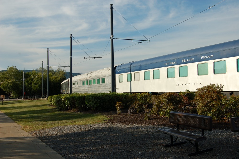 Historic grey, and white-and-blue passenger coaches