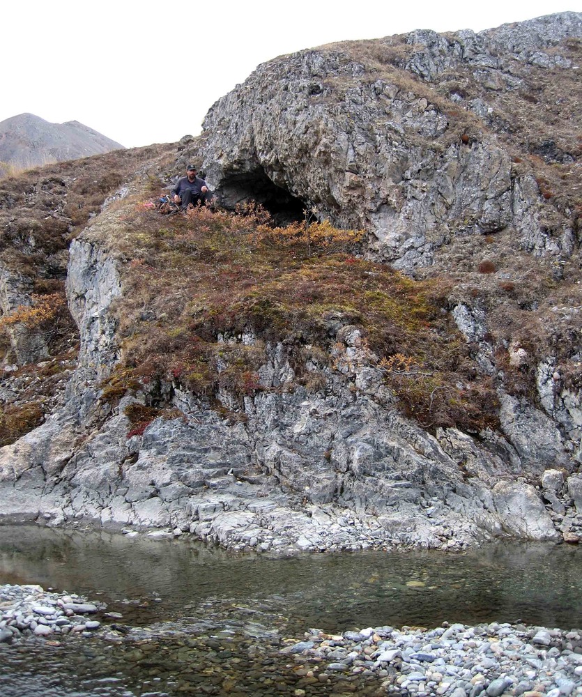 Scientist sitting outside a cave