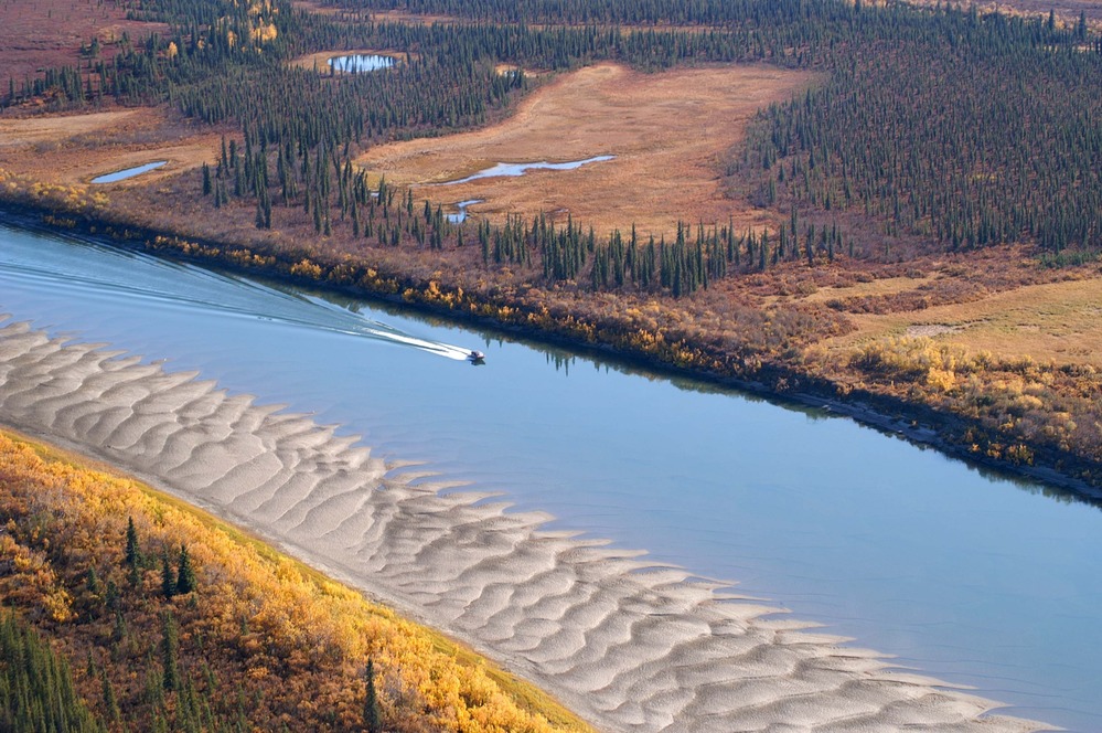 Aerial view of a motor boat on a river.